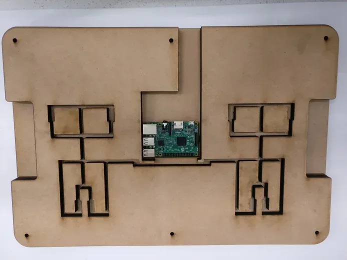 Full-scale laser-cut MDF Balance Board prototype with sensor pockets, wire channels, two foot platforms, and a Raspberry Pi in its central bay.