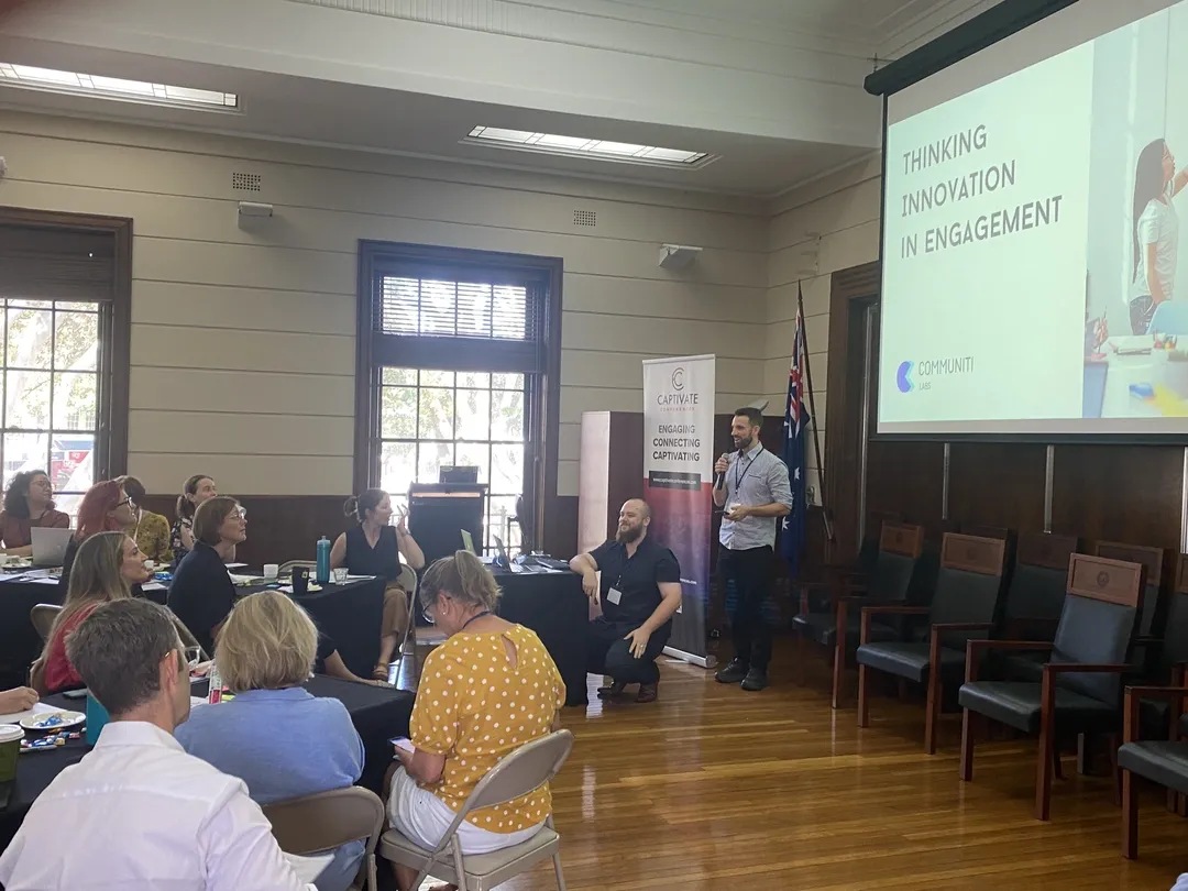 Dan Ferguson presenting the first public version of Communiti Analysis at Engage by the Beach in 2024, with Steven Germain seated beside him.